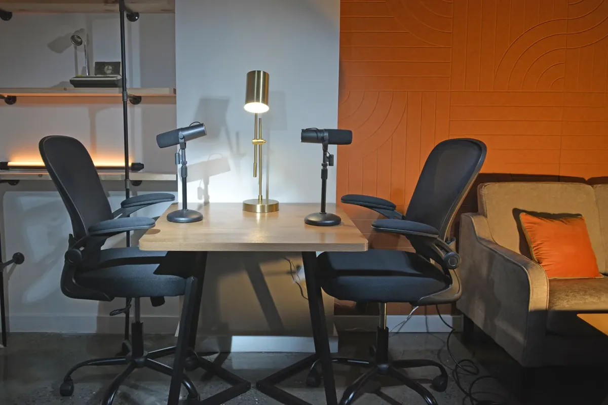 Bushwick podcast recording desk setup with orange acoustic wall